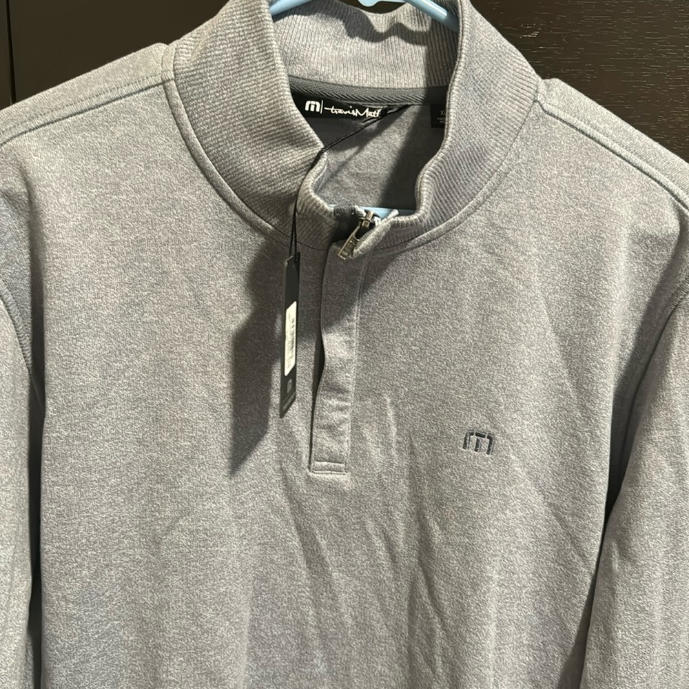 Travis Mathew sweater with Tito’s logo